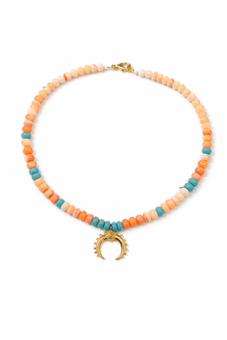 Opal beaded necklace with turquoise accents and gold crescent pendant on white background